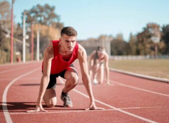 Male athlete starting a race.
