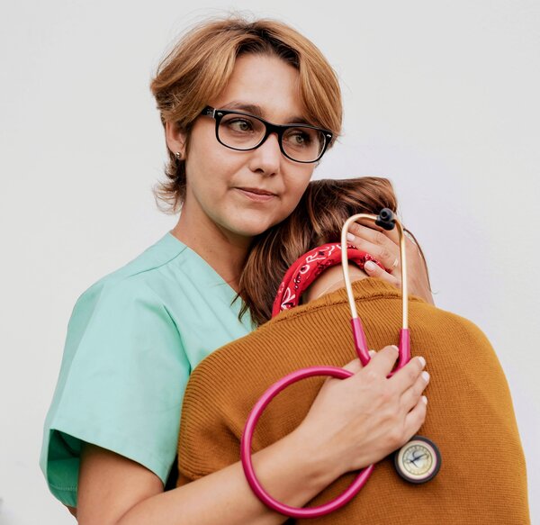 Female doctor comforting another person who is anxious and stressed