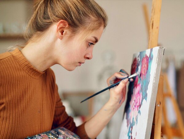 Woman composing art instead of writing an essay in age of AI