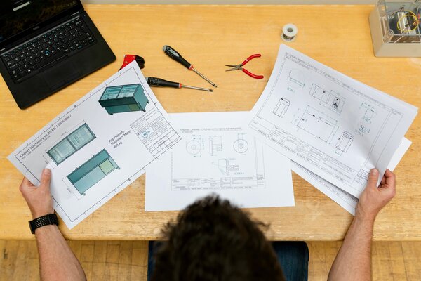 Engineer reviewing blueprints
