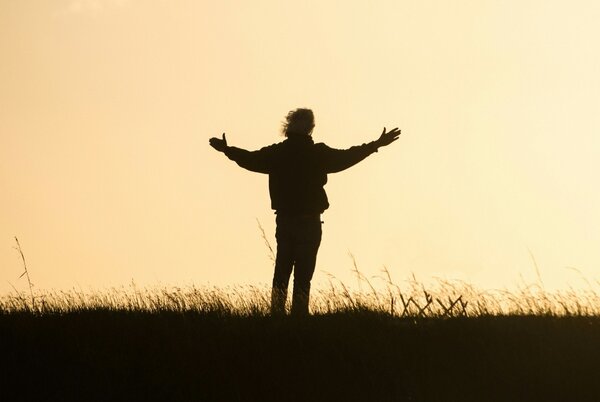 Person standing peacefully outside without anxiety or stress