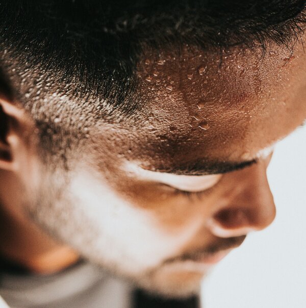 Man sweating after learning how to work hard on the grind