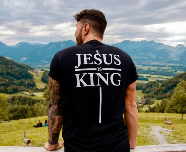 Man with shirt that says "Jesus is King"