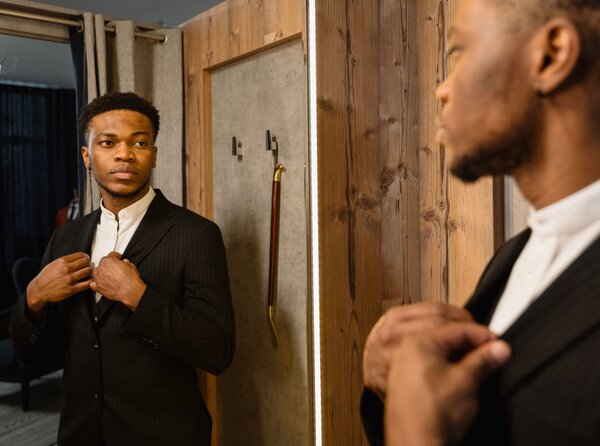Man recognizing his effort in the mirror to stay disciplined
