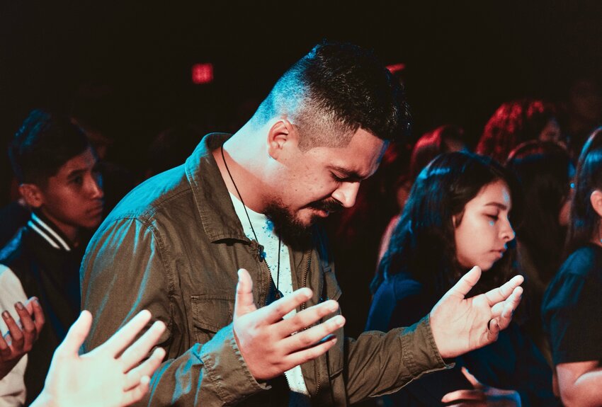 Man worshipping God in church.
