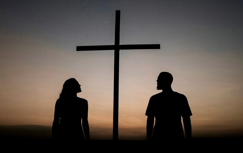 Couple in front of a cross